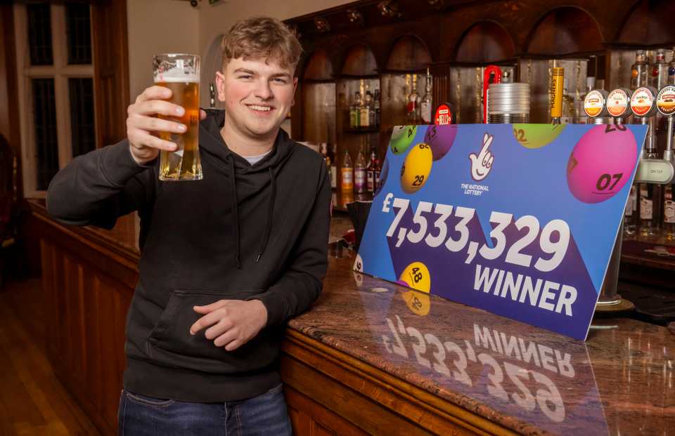 National Lottery winner holding a beer, celebrating his £7,533,329 win.