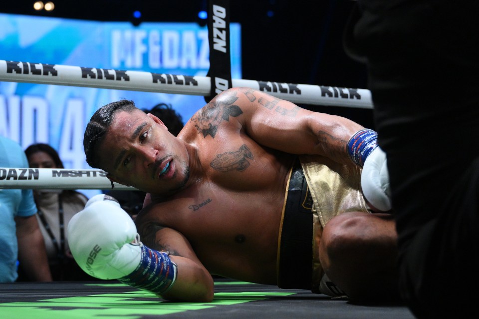 Anthony Taylor on the boxing ring floor after being knocked down.