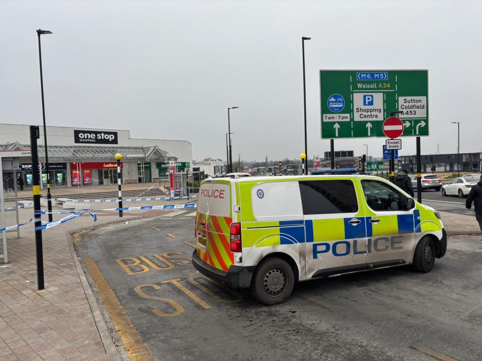 Police van at a closed-off Birmingham shopping center.