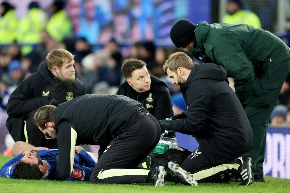 Armando Broja of Everton receiving medical attention on the field after an injury.