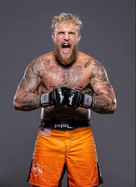 Portrait of a tattooed MMA fighter yelling.