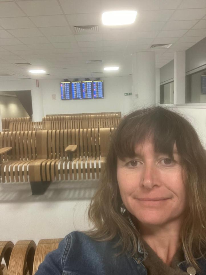 Woman in airport waiting area before a flight to France.