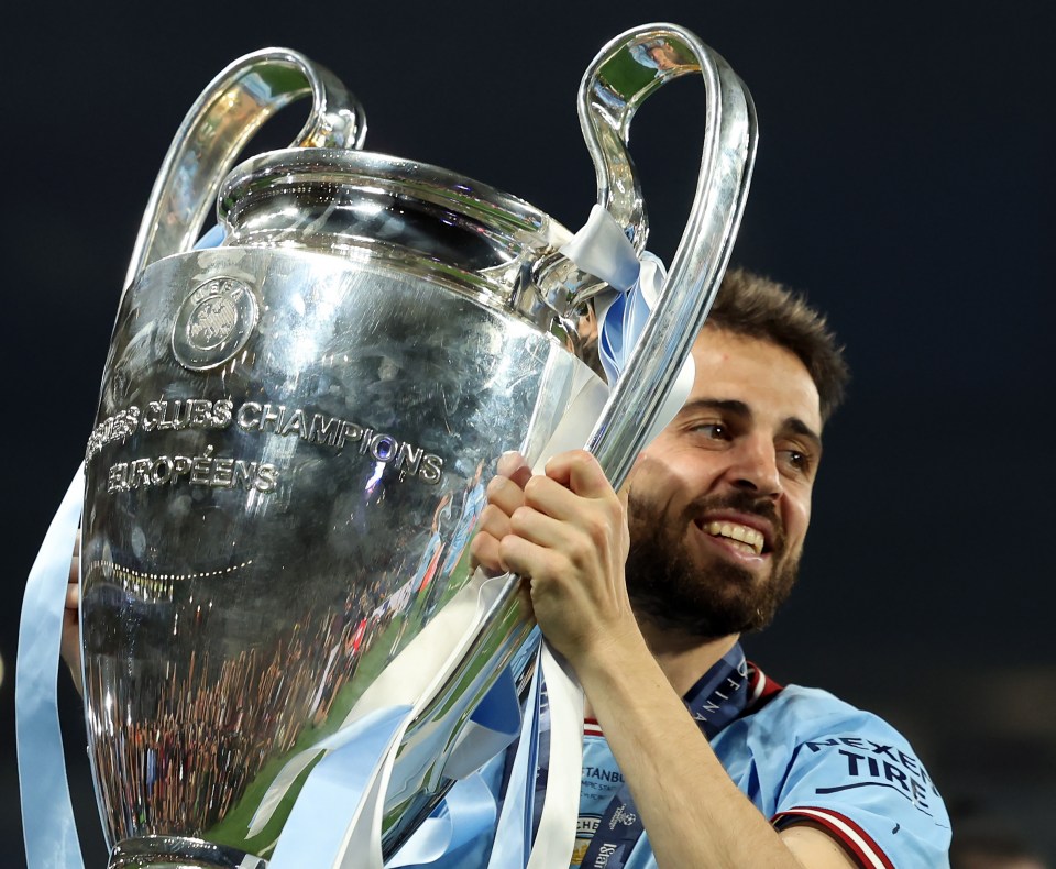 Bernardo Silva of Manchester City holding the UEFA Champions League trophy.