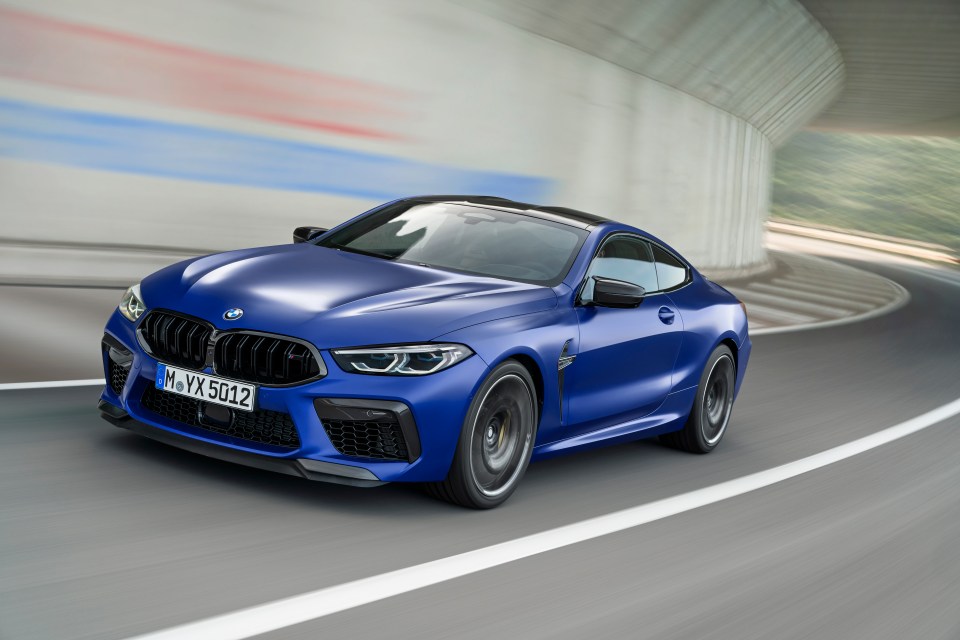 BMW M8 Coupe driving on a road.