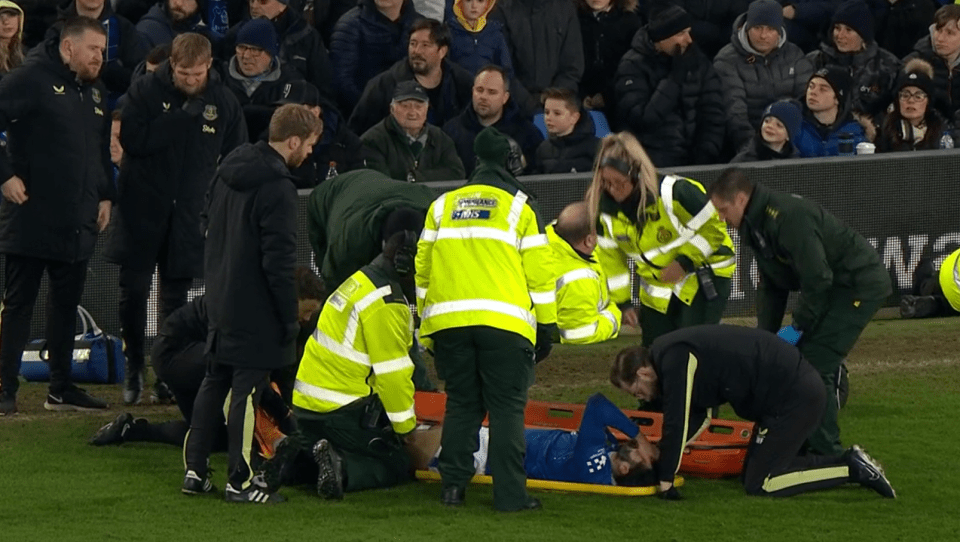 Injured soccer player being stretchered off the field.