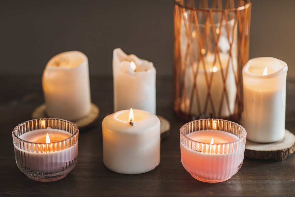 Burning candles on a wooden table.