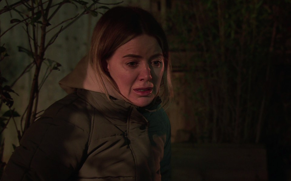 Abi Webster, upset and crying outdoors at night.