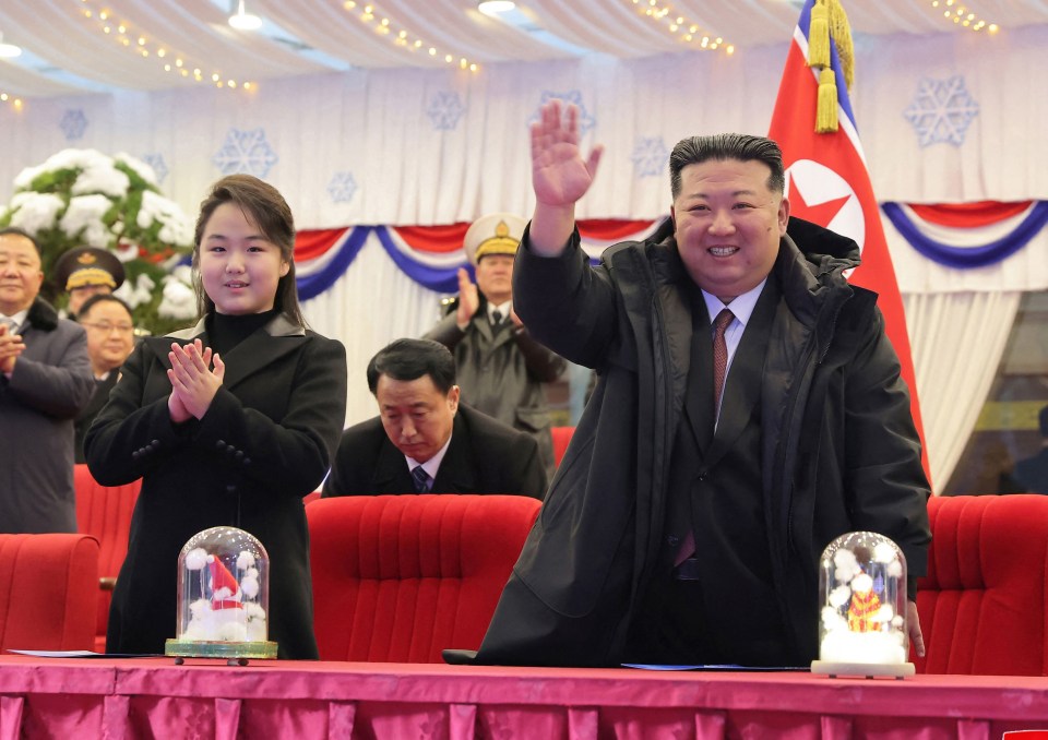 Kim Jong Un with his daughter Ju Ae waving as they attend a New Year performance