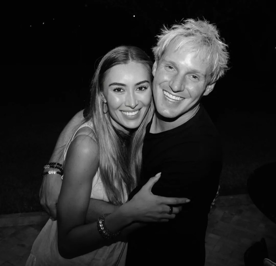 Black and white photo of Jamie Lainf and Sophie Habboo hugging.