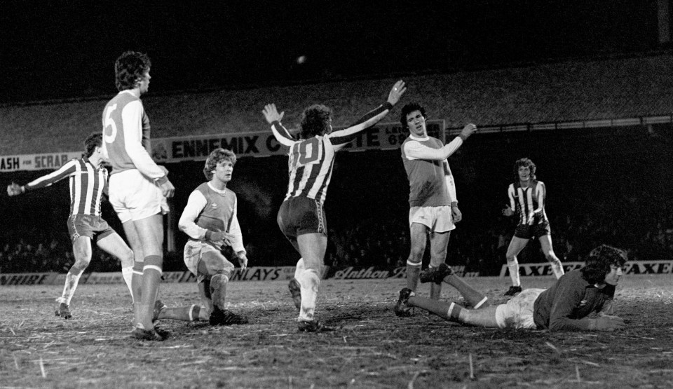 Black and white photo of a soccer game, showing a goal celebration.