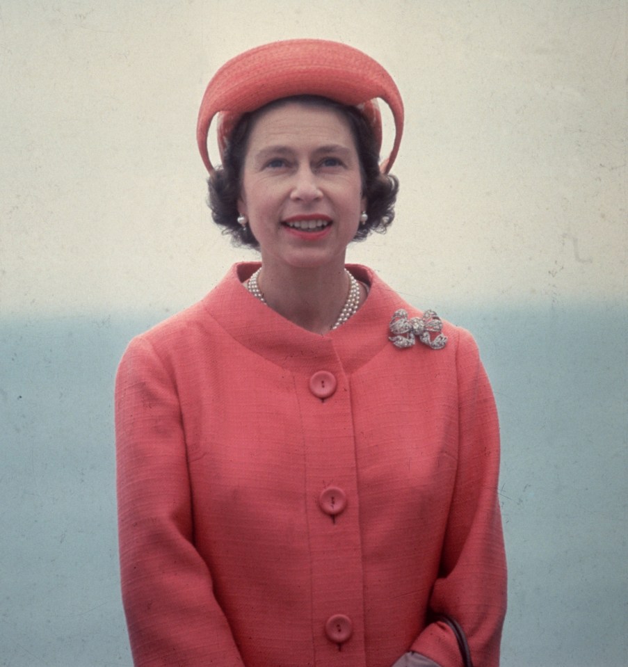 Portrait of Queen Elizabeth II in a pink suit and hat.