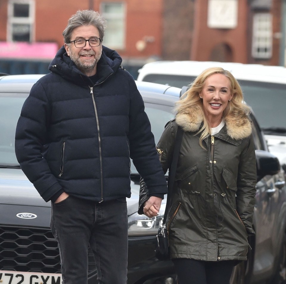 Mark Chapman and Clere Collier holding hands while walking.