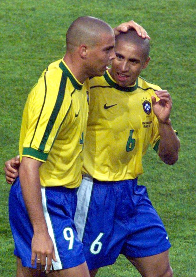 Ronaldo and Roberto Carlos of Brazil celebrate a goal.