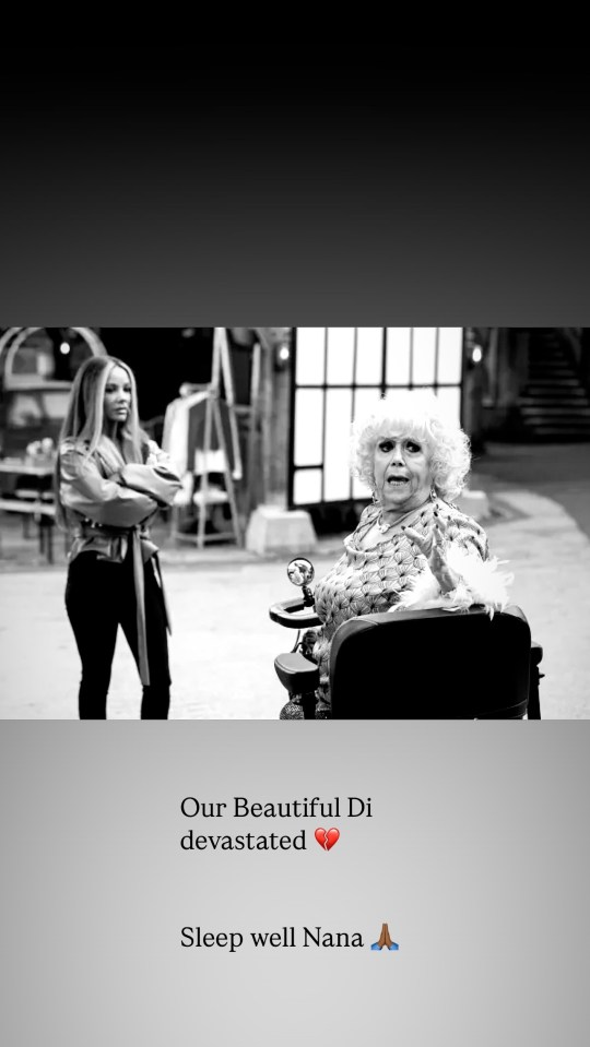 Black and white photo of two women; one standing, one seated in a wheelchair.