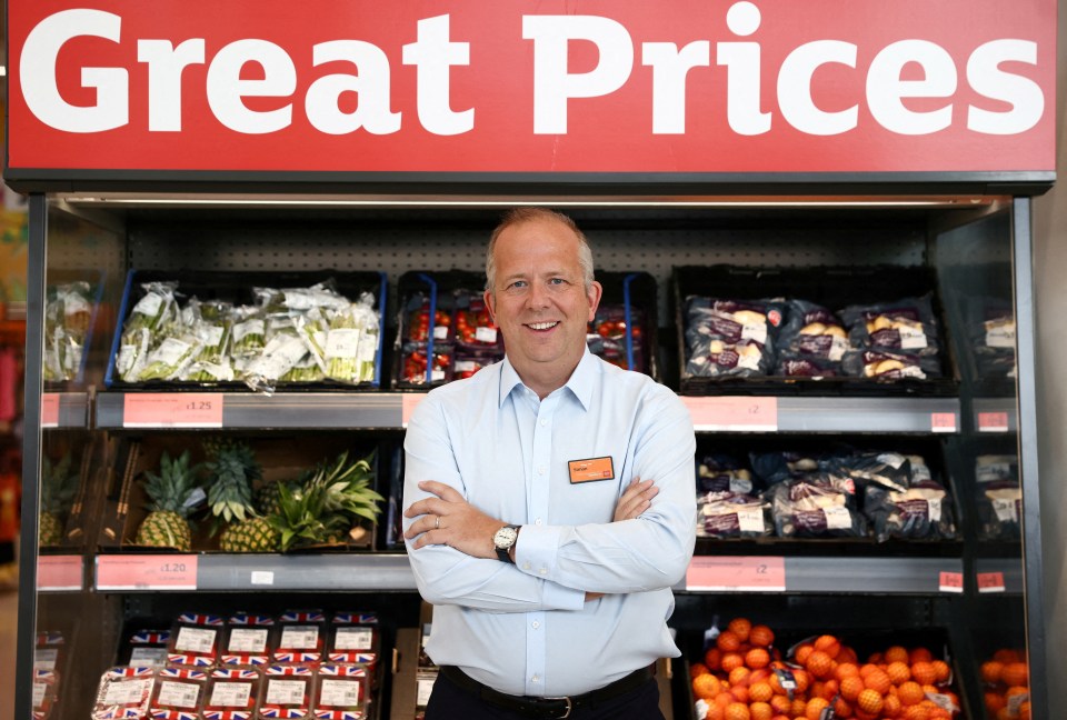 Sainsbury's CEO Simon Roberts standing in a supermarket.