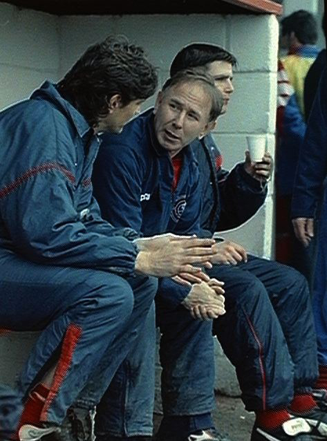 Chris Weller, assistant manager of Gravesend and Northfleet, in conversation with other managers.