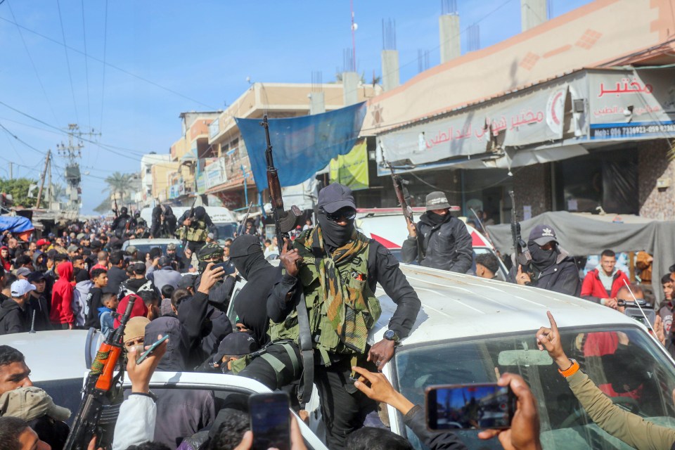 Civilians celebrating a ceasefire, some carrying guns.