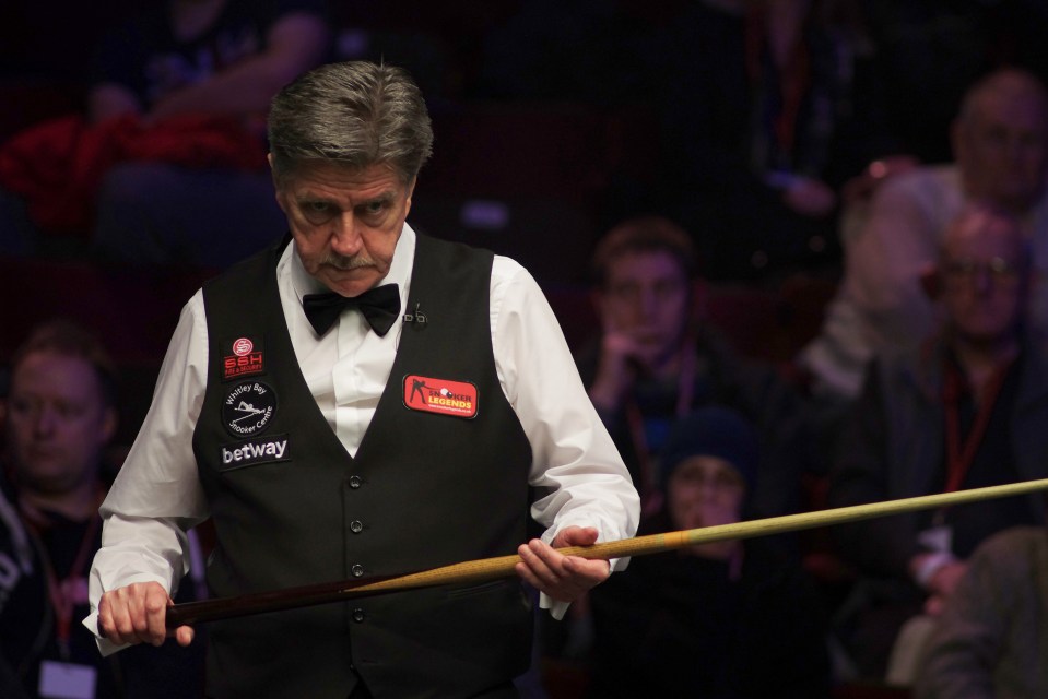 Cliff Thorburn, Canadian snooker player, holding his cue.