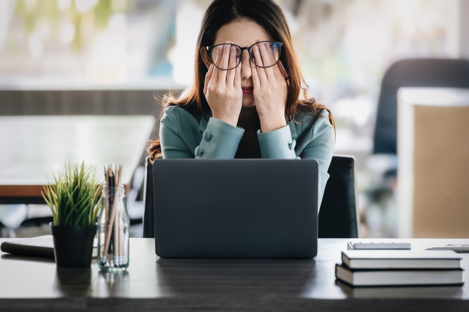 Businesswoman experiencing burnout at her desk.