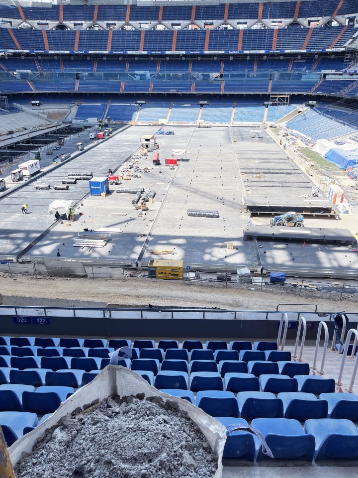 Construction workers renovating the Santiago Bernabéu Stadium's playing field.