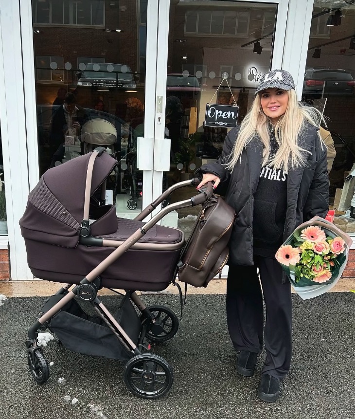 Lucy Fallon with a baby stroller and flowers.