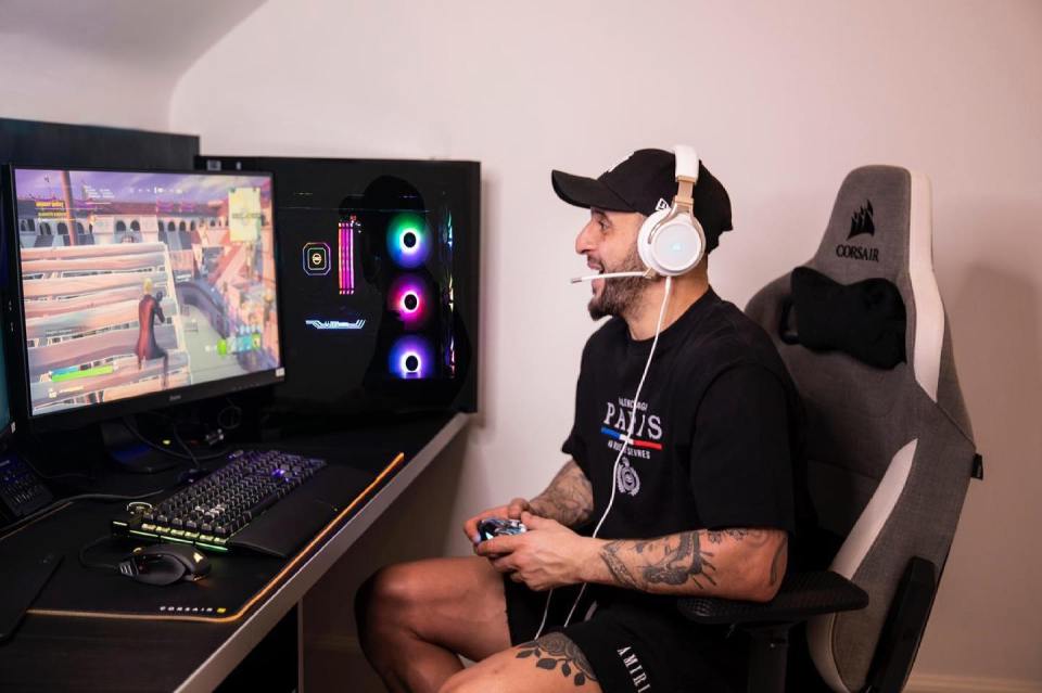 Man playing video game using Corsair, PCSpecialist, and SCUF Gaming gear.