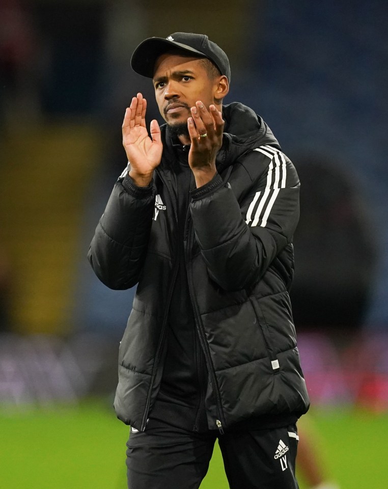 Crawley Town manager Lewis Young applauding.