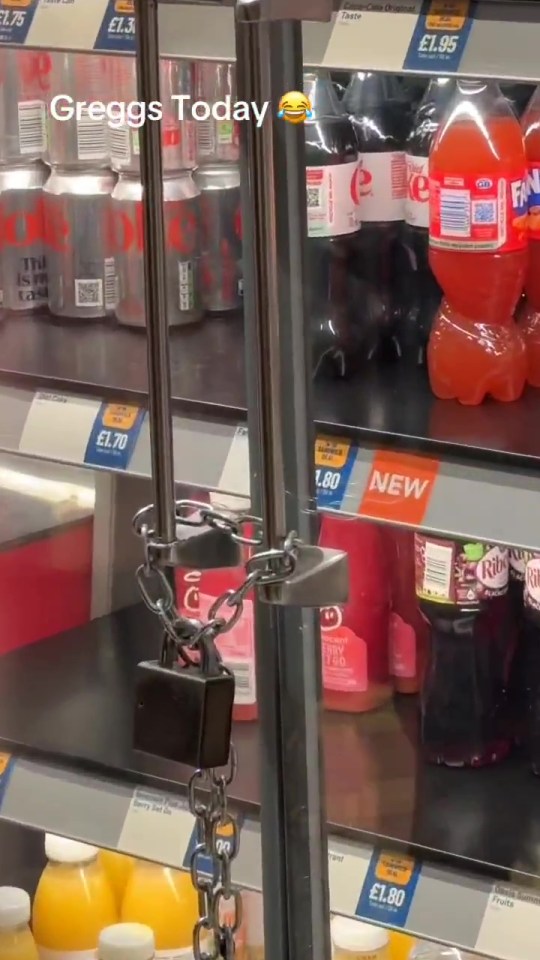 A Greggs display case locked with a chain and padlock.