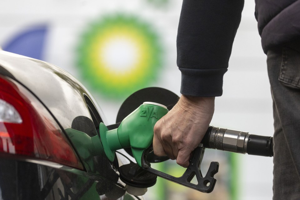 Person pumping gas at a BP gas station.