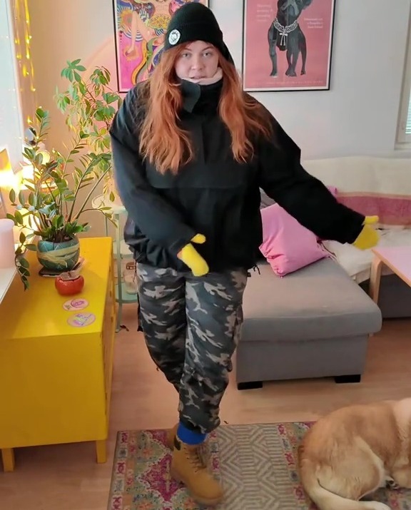 Person wearing winter clothes in a living room.