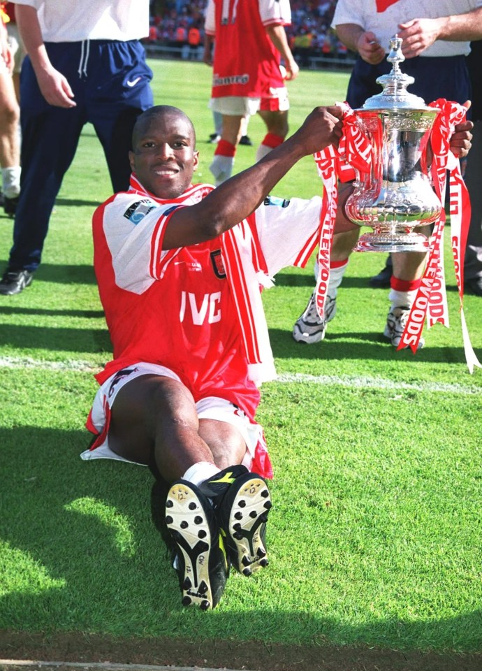 Christopher Wreh celebrates with the FA Cup after an Arsenal victory.