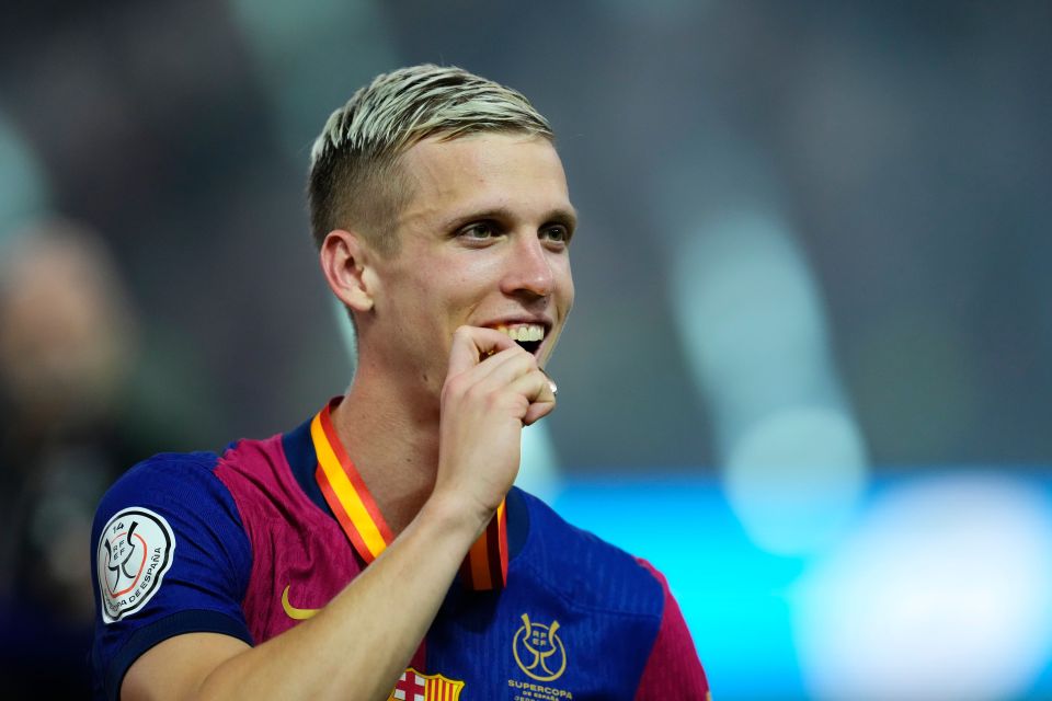 Dani Olmo of FC Barcelona holding a medal after a victory.