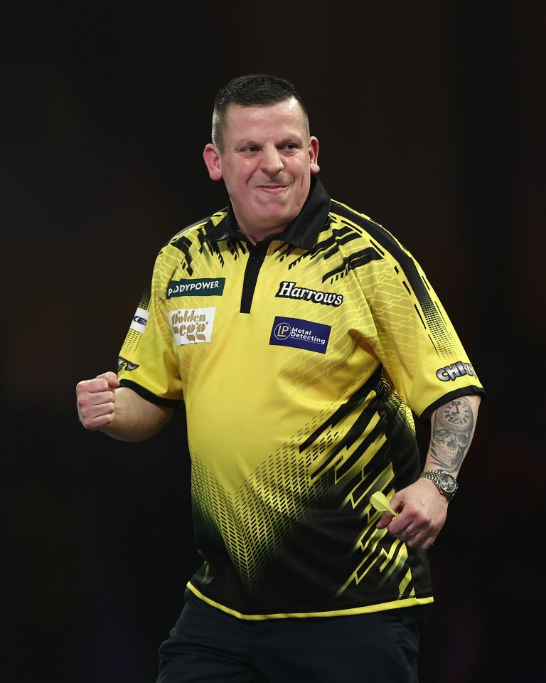 Dave Chisnall celebrating during a darts match.