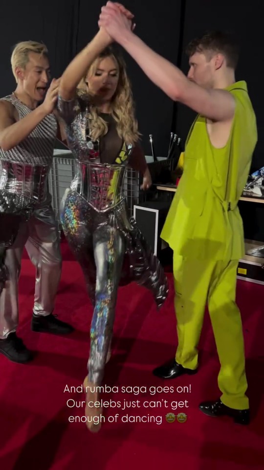 Three dancers on a red carpet; one in a silver sequined outfit, two others in contrasting colors.