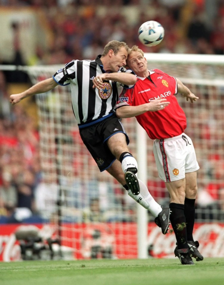 David May and Alan Shearer contesting for the ball.