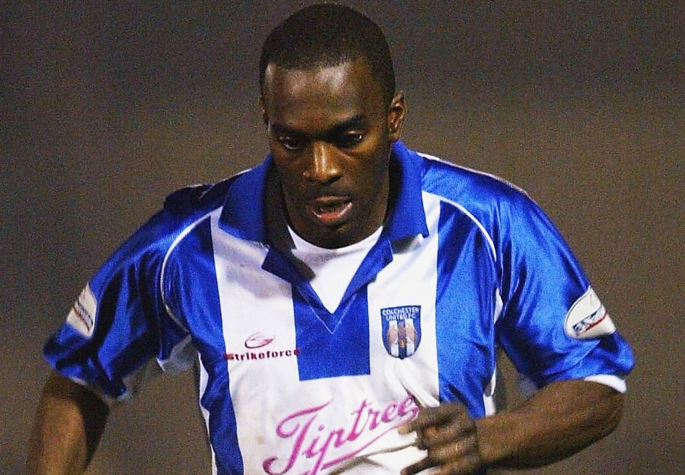 Soccer player in blue and white uniform dribbling the ball.