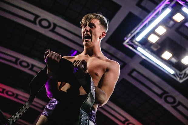 A wrestler holding championship belts.