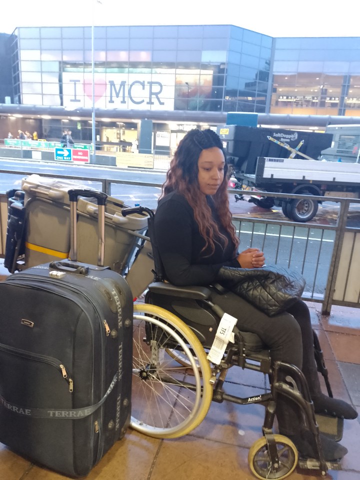 Woman in wheelchair at Manchester Airport gate after being prevented from boarding a flight due to damage to her husband's passport.