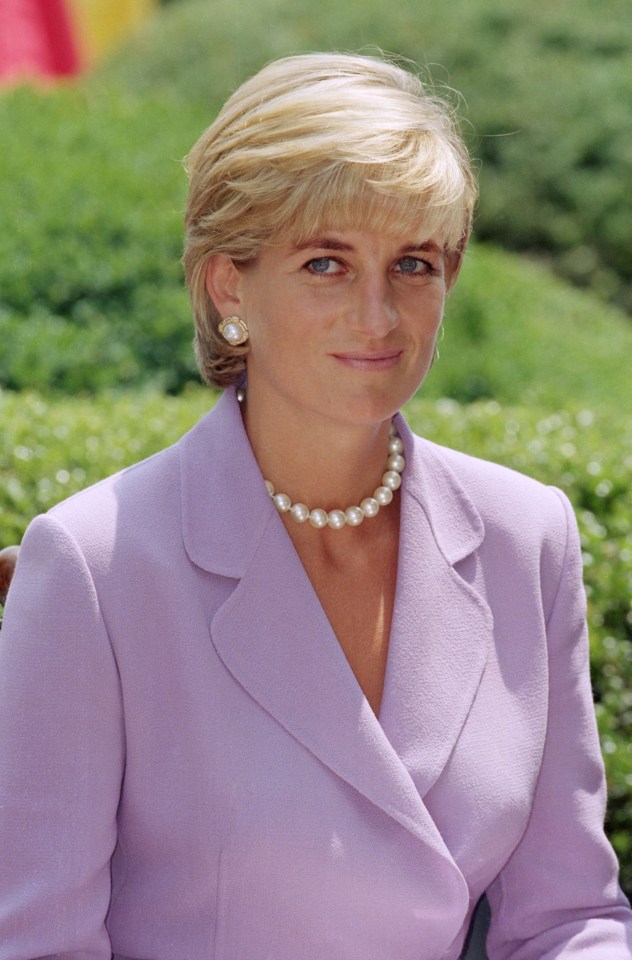 Portrait of Princess Diana wearing a lavender suit and pearl necklace.