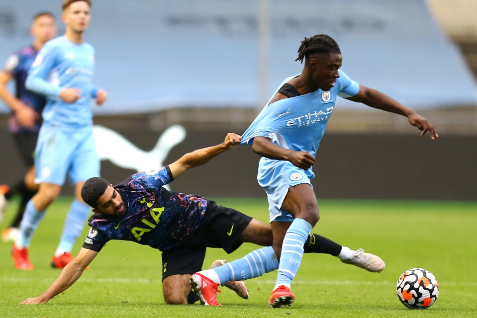 Dilan Markanday of Tottenham Hotspur challenges Romeo Lavia of Manchester City during a soccer match.