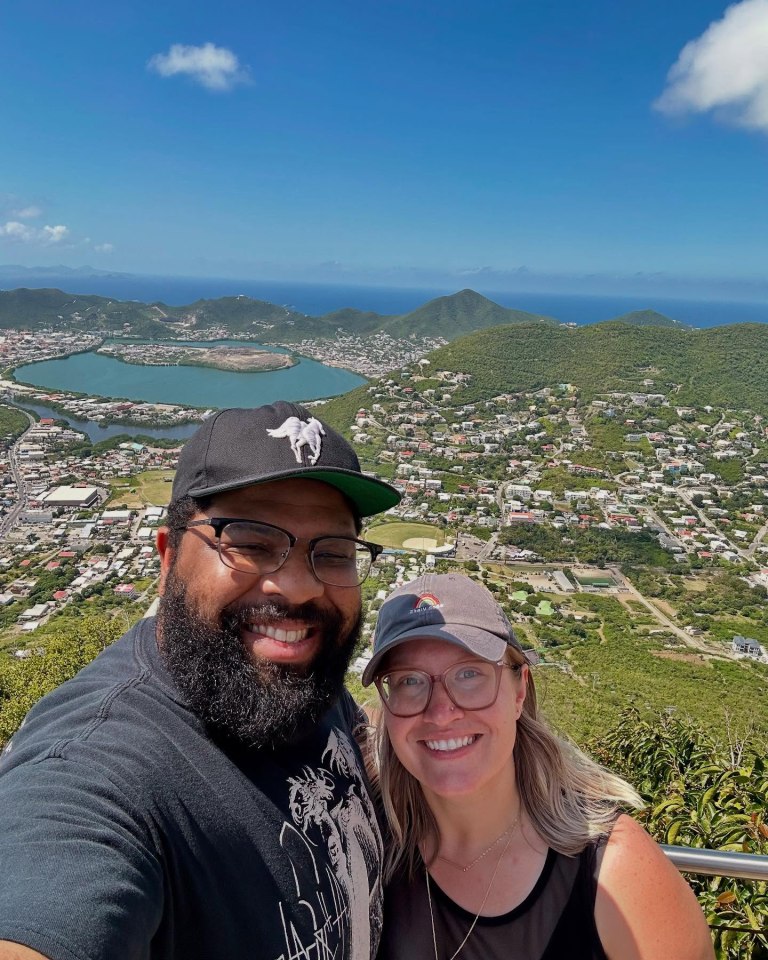 Selfie of a couple overlooking a city and ocean.