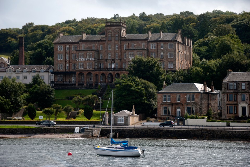 The Glenburn Hotel in Rothesay, Isle of Bute, with a sailboat in the foreground.