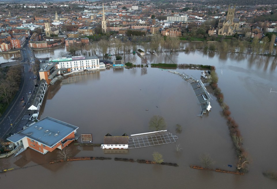 Aerial view of a cricket ground submerged in floodwater.