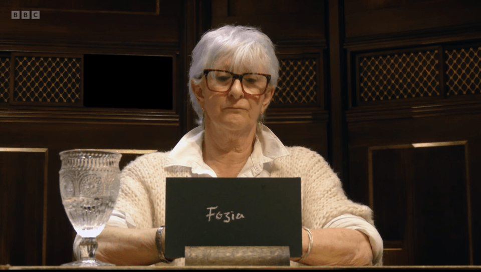 Linda from The Traitors holding a slate that reads "Fozia".