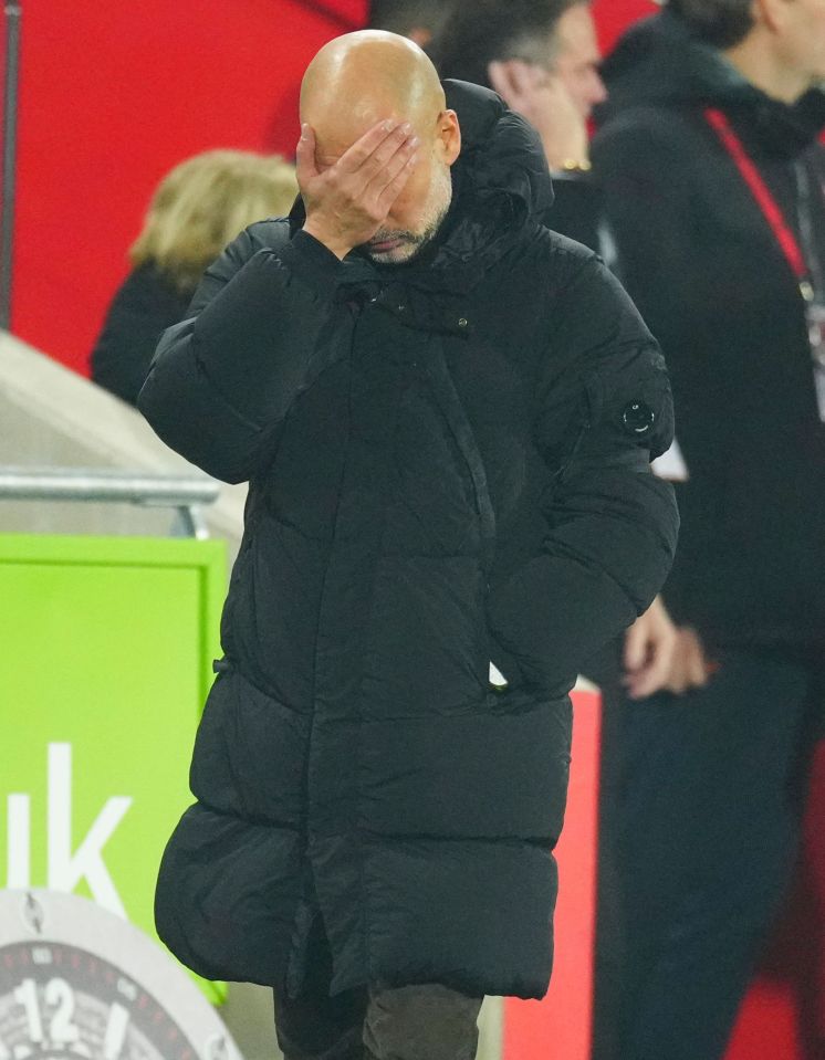 Pep Guardiola covering his face with his hand.