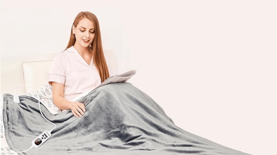 Woman using an electric blanket while reading.