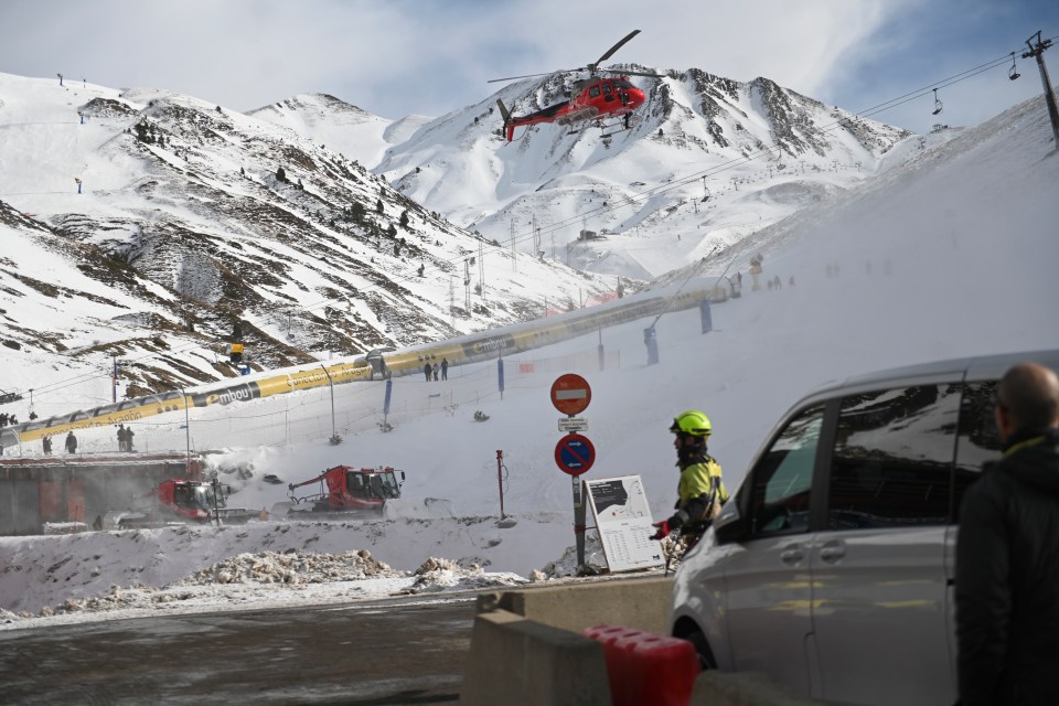 Emergency helicopter over ski lifts.