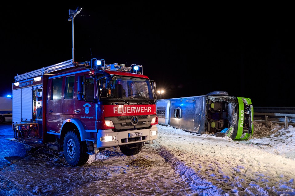 Bus crash scene with fire trucks in the snow.