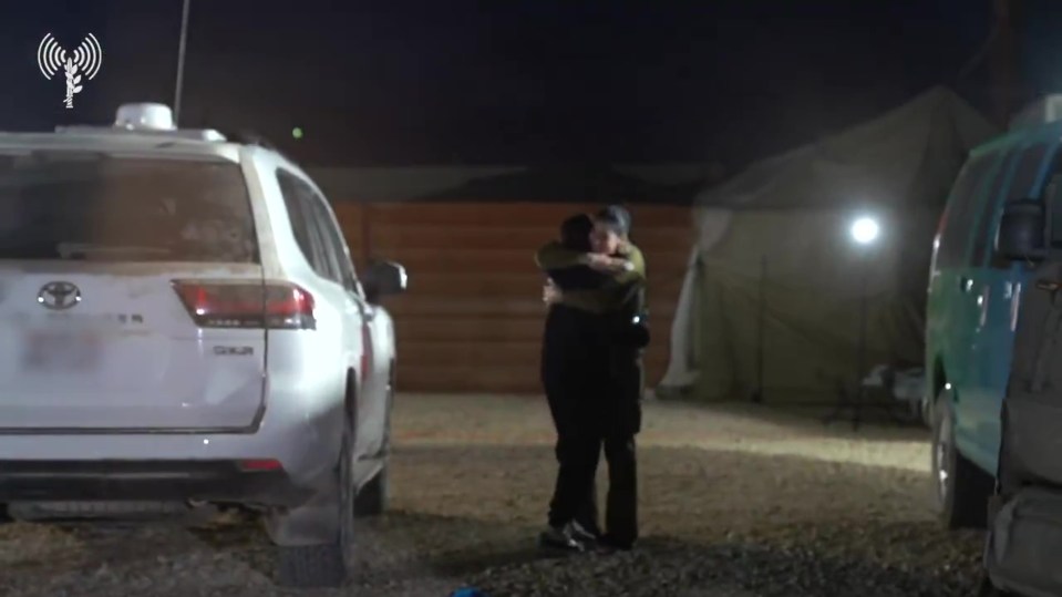 Released Israeli hostages embracing.