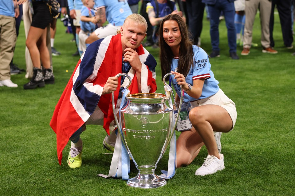 Erling Haaland and Isabel Johansen with the UEFA Champions League trophy.